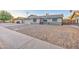 Charming single-story home featuring a spacious front yard with stone landscaping and a two-car garage at 2122 E Radcliffe Dr, Tempe, AZ 85283