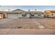 Charming single-story home featuring a spacious front yard with stone landscaping and a two-car garage at 2122 E Radcliffe Dr, Tempe, AZ 85283