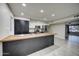 Modern kitchen with stainless steel appliances, a large center island, and plenty of cabinet space at 2122 E Radcliffe Dr, Tempe, AZ 85283
