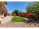 Lush backyard with manicured artificial lawn and stone-accented landscape at 21893 N 261St N Ave, Buckeye, AZ 85396
