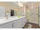 Spacious bathroom featuring dual sinks, a large mirror, and a walk-in shower at 21893 N 261St N Ave, Buckeye, AZ 85396