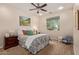 Charming bedroom with a window, ceiling fan and a comfortable chair at 21893 N 261St N Ave, Buckeye, AZ 85396