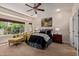 Serene bedroom featuring a cozy sitting area, large windows, and neutral decor at 21893 N 261St N Ave, Buckeye, AZ 85396