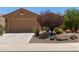 Charming home featuring a neutral color scheme, well-manicured landscaping, and a spacious two-car garage at 21893 N 261St N Ave, Buckeye, AZ 85396