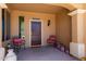 Inviting covered front porch with stylish decor and cozy seating for relaxing and enjoying the outdoors at 21893 N 261St N Ave, Buckeye, AZ 85396