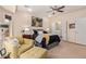 Comfortable main bedroom with a sitting area, ensuite bath and ceiling fan at 21893 N 261St N Ave, Buckeye, AZ 85396
