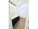 Bright bathroom features a black vanity with a white countertop and modern lighting fixture at 22523 W Pima St, Buckeye, AZ 85326