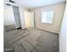 This bedroom features neutral walls, carpet, a window, and a sliding door closet at 22523 W Pima St, Buckeye, AZ 85326