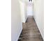 Hallway featuring dark wood-look flooring that leads to other rooms at 22523 W Pima St, Buckeye, AZ 85326