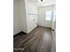 Bright laundry room with wood-look flooring and a single window at 22523 W Pima St, Buckeye, AZ 85326