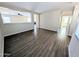 Open living room with wood-look floors, neutral walls, and staircase at 22523 W Pima St, Buckeye, AZ 85326