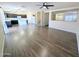 Bright, open living area features wood flooring, seamlessly connecting to the kitchen with dark cabinets at 22523 W Pima St, Buckeye, AZ 85326