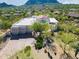 Aerial view of a desert home with lush landscaping, a red tile roof, and a brick driveway at 24724 N 119Th Pl, Scottsdale, AZ 85255