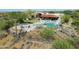 Aerial view of a desert home with a pool, lush landscaping, and a fire pit at 24724 N 119Th Pl, Scottsdale, AZ 85255