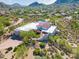 Aerial view of a desert home with lush landscaping, a pool, and mountain views at 24724 N 119Th Pl, Scottsdale, AZ 85255