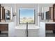 Well-lit bathroom featuring dual vanities and a soaking tub with desert views at 24724 N 119Th Pl, Scottsdale, AZ 85255