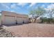 Wide brick driveway leading to a three car garage with desert landscaping and a welcoming arched entryway at 24724 N 119Th Pl, Scottsdale, AZ 85255