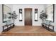 Inviting foyer with modern wood door, side windows, stylish benches, and herringbone wood flooring at 24724 N 119Th Pl, Scottsdale, AZ 85255