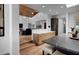 Open kitchen with modern island seating, stainless appliances, and seamless view to living space at 24724 N 119Th Pl, Scottsdale, AZ 85255