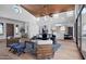 Open-concept living room with modern decor, wood ceiling, and seamless flow to the kitchen at 24724 N 119Th Pl, Scottsdale, AZ 85255