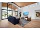 Bright living room with floor to ceiling windows, wood ceiling, hardwood floors, and modern furnishings at 24724 N 119Th Pl, Scottsdale, AZ 85255