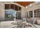 Cozy outdoor patio featuring comfortable seating, a white stucco exterior, and large glass windows at 24724 N 119Th Pl, Scottsdale, AZ 85255
