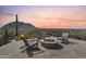 Inviting outdoor area with comfortable seating around a modern fire pit with scenic mountain views at 24724 N 119Th Pl, Scottsdale, AZ 85255