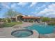 Beautiful pool and spa with lush landscaping, a putting green, and an outdoor patio area perfect for entertaining at 24724 N 119Th Pl, Scottsdale, AZ 85255