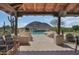 Inviting pool and outdoor seating area with a view of the desert landscape and mountains at 24724 N 119Th Pl, Scottsdale, AZ 85255