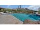 Close up of an inviting pool with clear blue water, desert landscaping, and mountain views at 24724 N 119Th Pl, Scottsdale, AZ 85255