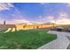 This spacious backyard is fully fenced with lush lawn, brick pavers, and a barbecue area at 25969 W Tina Ln, Buckeye, AZ 85396