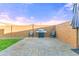 Enjoy outdoor living in this backyard featuring a barbecue area, brick pavers, and seating at 25969 W Tina Ln, Buckeye, AZ 85396