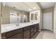 Bathroom featuring dual sinks, tile flooring, and a glass enclosed walk-in shower at 25969 W Tina Ln, Buckeye, AZ 85396