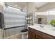 Well lit bathroom featuring tile flooring, a shower, and a dark wood vanity at 25969 W Tina Ln, Buckeye, AZ 85396