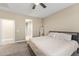 Serene bedroom featuring plush carpeting, ceiling fan, and easy access to the rest of the home at 25969 W Tina Ln, Buckeye, AZ 85396