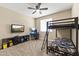 Well lit bedroom featuring carpet, ceiling fan, and a bunk bed at 25969 W Tina Ln, Buckeye, AZ 85396