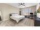 Bright bedroom featuring a neutral color scheme, desk, and ample natural light at 25969 W Tina Ln, Buckeye, AZ 85396