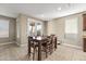The open dining area adjacent to the kitchen, featuring a dining table and chairs at 25969 W Tina Ln, Buckeye, AZ 85396