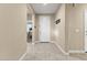 Inviting entryway featuring neutral tones, tile flooring, and a coat rack for added convenience at 25969 W Tina Ln, Buckeye, AZ 85396