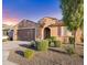 Inviting single-story home featuring a well-kept lawn, desert landscaping, and a two-car garage for modern living at 25969 W Tina Ln, Buckeye, AZ 85396