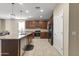 Spacious kitchen boasts stainless steel appliances, dark cabinetry, granite counters and a large center island at 25969 W Tina Ln, Buckeye, AZ 85396