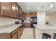 Modern kitchen design with dark wood cabinets, stainless steel appliances, and granite countertops at 25969 W Tina Ln, Buckeye, AZ 85396