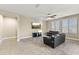 The living room has tile floors, neutral paint, a ceiling fan, and two large leather sofas at 25969 W Tina Ln, Buckeye, AZ 85396