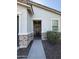 Exterior entrance with decorative stone, neutral paint and desert landscaping at 37287 N Azteca Rd, San Tan Valley, AZ 85140