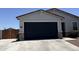 View of the two car garage and long driveway, with a fenced yard on a sunny day at 37287 N Azteca Rd, San Tan Valley, AZ 85140