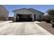 Two car garage with open door and view of contents, as well as long driveway at 37287 N Azteca Rd, San Tan Valley, AZ 85140