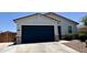 A two-car garage with a long concrete driveway, and well kept landscaping at 37287 N Azteca Rd, San Tan Valley, AZ 85140