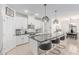Well-lit kitchen with a large island, modern light fixtures, and stainless steel appliances at 37287 N Azteca Rd, San Tan Valley, AZ 85140