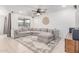 Bright living room with a large sectional sofa, ceiling fan, and decorative elements at 37287 N Azteca Rd, San Tan Valley, AZ 85140