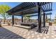 Outdoor pergola featuring shaded seating and dining area for neighborhood gatherings and entertainment at 37287 N Azteca Rd, San Tan Valley, AZ 85140